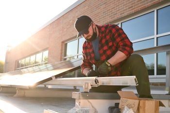 Jacob Grant working on solar panels