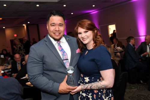Eric Peterson and wife Ashley Peterson hold the John M. Fulton Distinguished Alumni Award