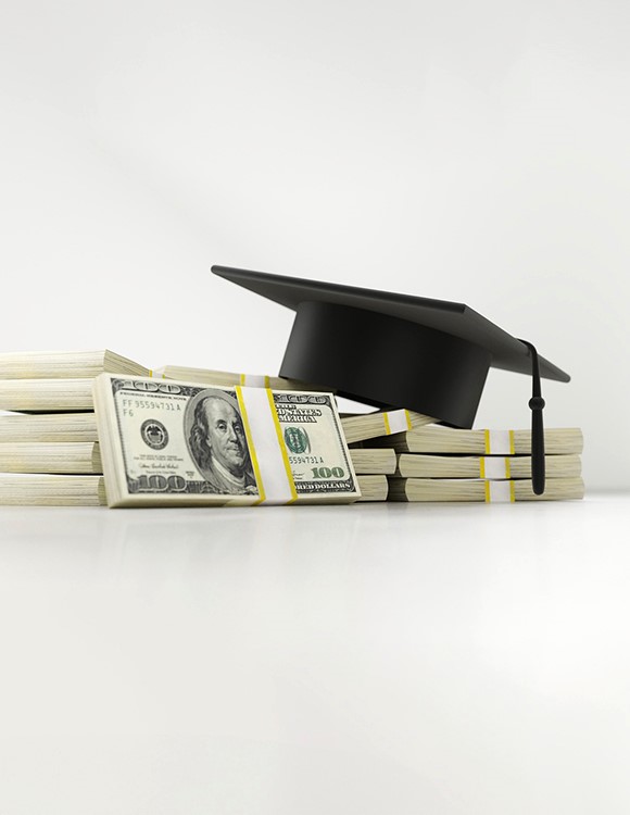 An image of a graduation cap on top of cash