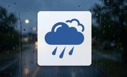 Rain icon with rainy street behind it.